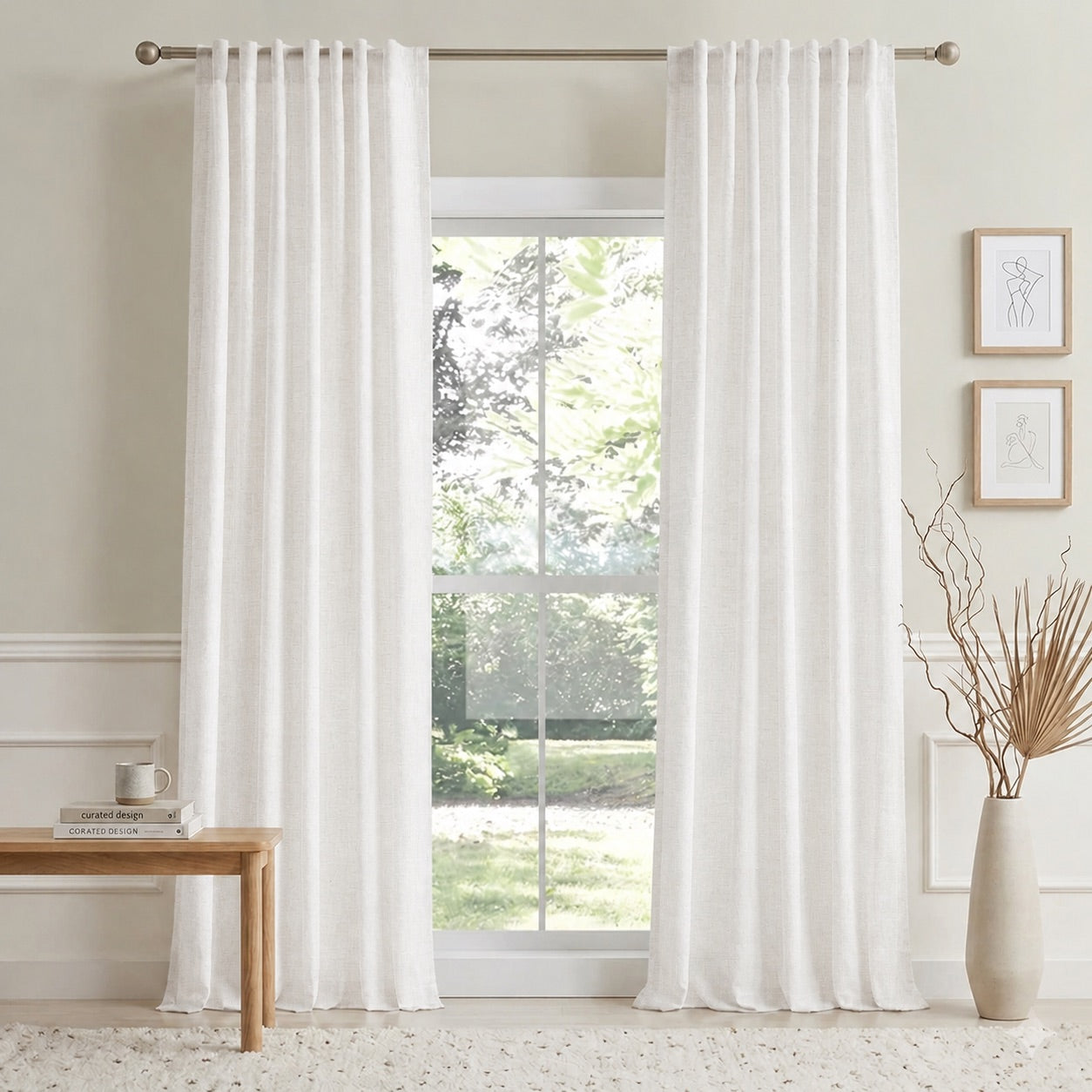 Off-white cotton-linen curtains with pleated header hanging on a window rod