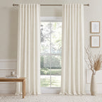 Off-white cotton-linen curtain panels with vertical pleats on a window rod