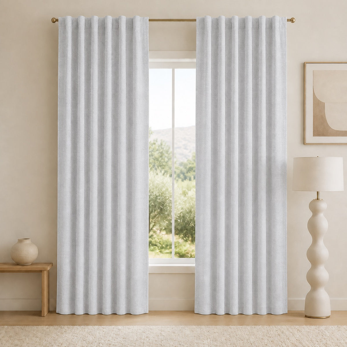 Light gray blackout curtains with vertical pleats and grommet top, open window view behind.
