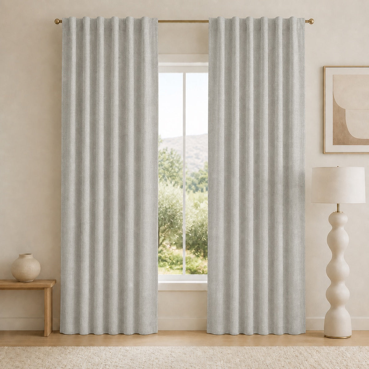 Light gray blackout curtains with grommet top and tall pleats, centered in front of window.