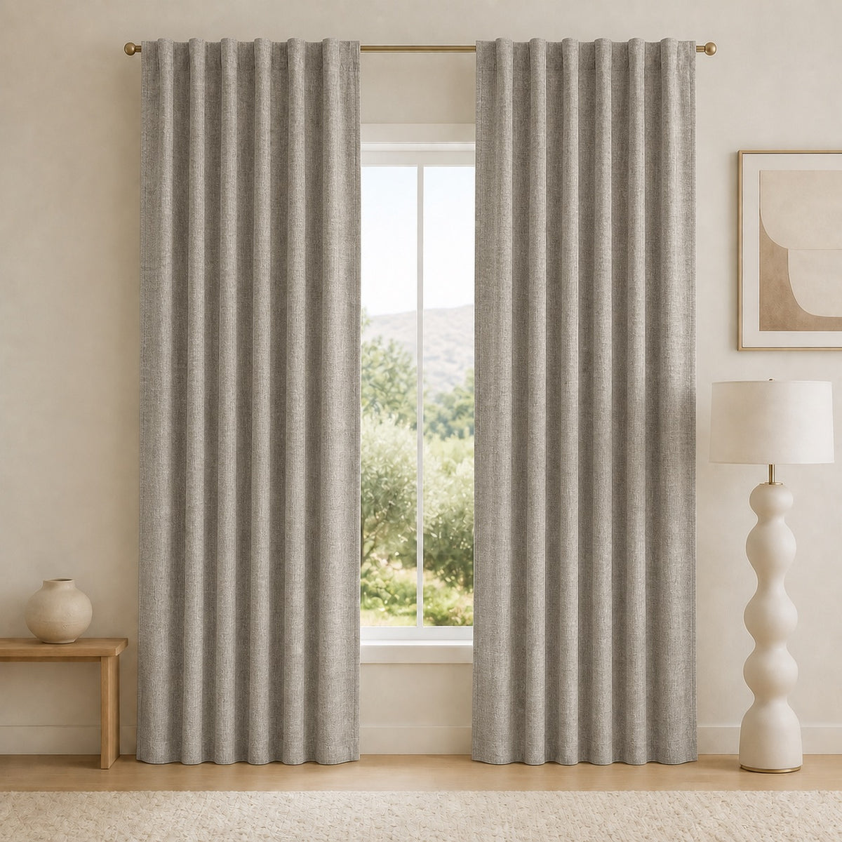 Mid-gray blackout curtains with grommet top and deep vertical pleats, mounted on a rod.