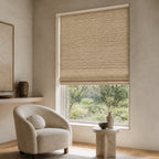 Light beige woven bamboo roller shade with tight basketweave texture over a window.