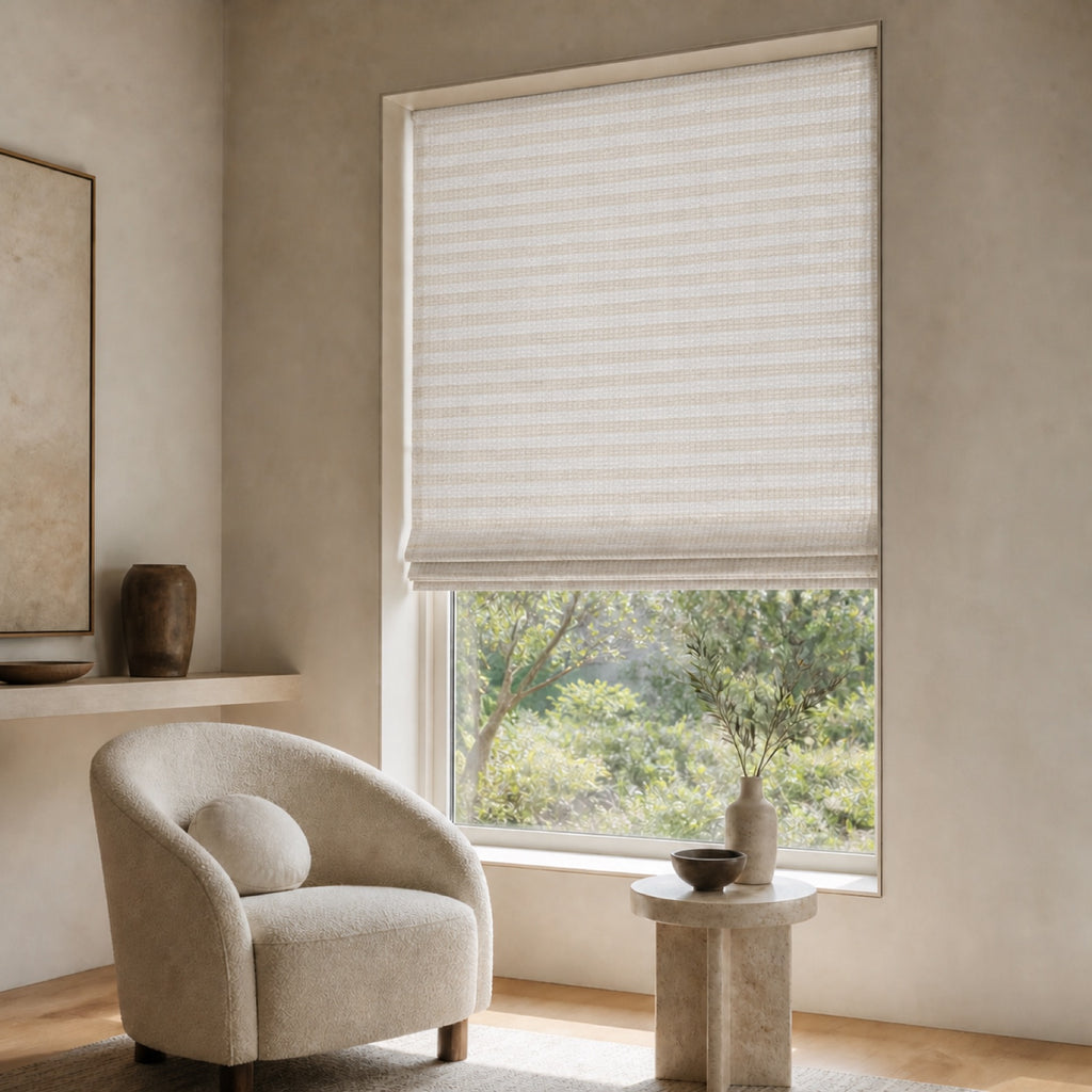 Soft white woven bamboo roller shade with fine horizontal stripe texture over a window.