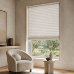 Soft white woven bamboo roller shade with fine horizontal stripe texture over a window.