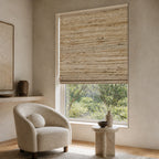 Beige woven bamboo roller shade with mixed horizontal and vertical thread pattern over a window.