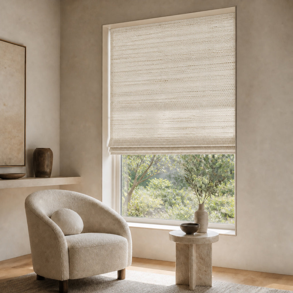 Light beige woven bamboo roller shade with subtle basketweave texture over a window.
