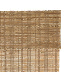 Bamboo woven shade with open lattice pattern in light to medium tan, layered for privacy.