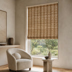Golden-brown woven bamboo roller shade with open lattice texture over a window.