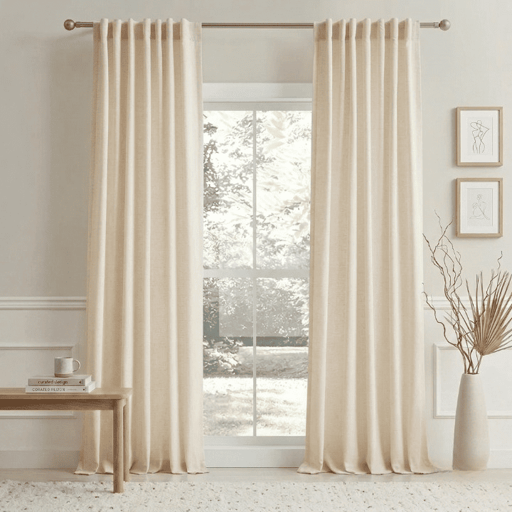 Pair of light beige linen curtains with vertical pleats and rod pocket