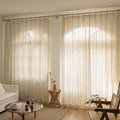Linen-blend sheer curtains with vertical stripe pattern, gathered at a top rod pocket.
