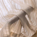 Sheer curtain fabric detail with vertical stripes and soft, light beige tone.