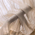 Sheer curtain fabric detail with vertical stripes and soft, light beige tone.