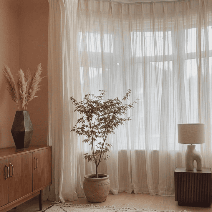 White sheer curtain panels with vertical stripes, softly gathered with ruffled header.