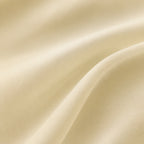 Light cream sheer curtain fabric close-up with fine woven texture and soft drape