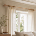 Light beech solid wood curtain rod with circular finials and wall-mounted bracket